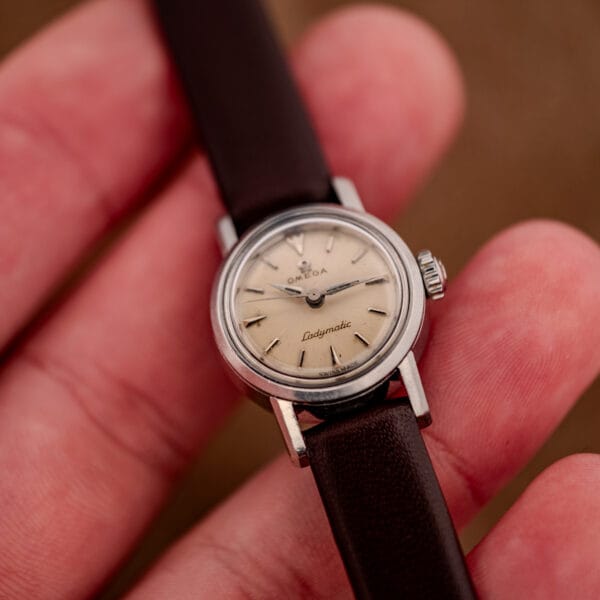 Omega Ladymatic 11000-7 silver dial in hand showing the small late-1950s case size