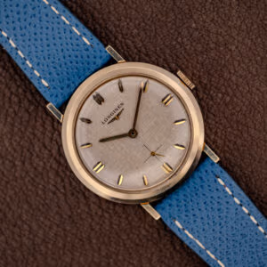Vintage Longines Ref. 1116 white linen textured dial with gold faceted markers on a blue leather strap