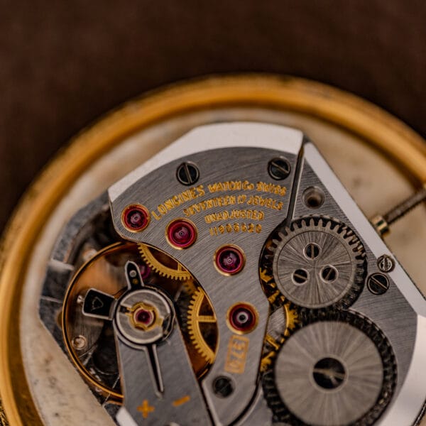Longines caliber 370 movement bridge signed LONGINES WATCH CO SWITZERLAND and marked UNADJUSTED