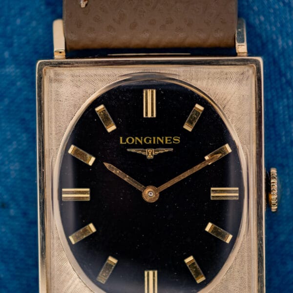 Longines 3007-528 dial close-up, gilt LONGINES winged hourglass logo and applied gold baton markers on glossy black