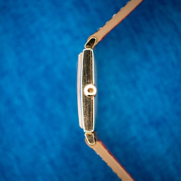 Longines Tank 3007-528 case side profile showing yellow 10k gold-filled finish and signed crown