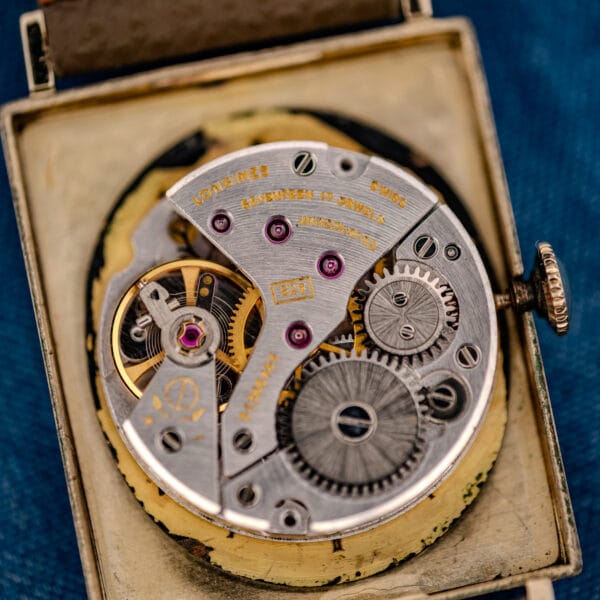 Longines caliber 528 movement close-up, LONGINES-signed bridge, balance wheel and ruby jewels