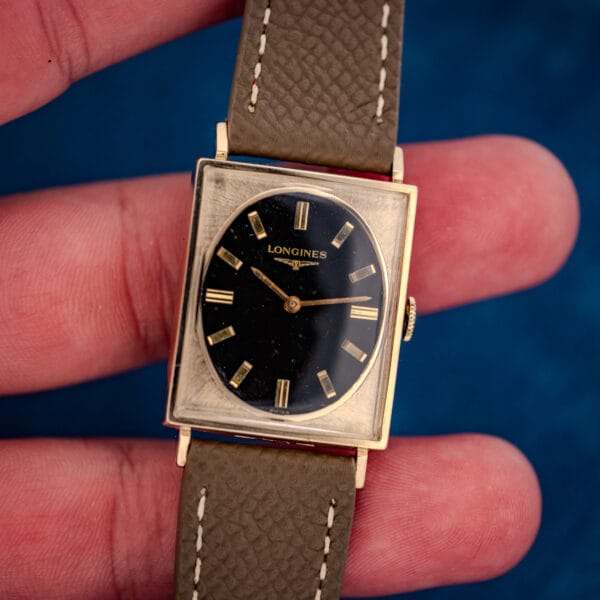 Longines Tank 3007-528 in hand, gilt LONGINES signature and SWISS printed on glossy black oval dial