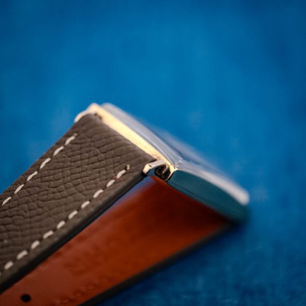 Longines 3007-528 strap detail, mud-grey grained leather with cream stitching near gold-filled lug