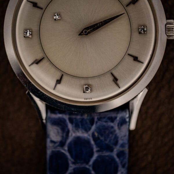 Longines 69-230-2A dial detail showing SWISS signature at six and the signed winding crown
