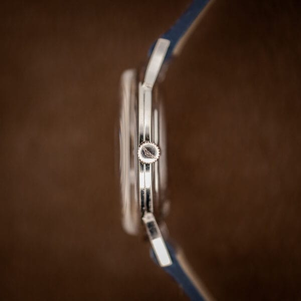 Longines 69-230-2A side profile showing the signed crown and faceted white gold lugs