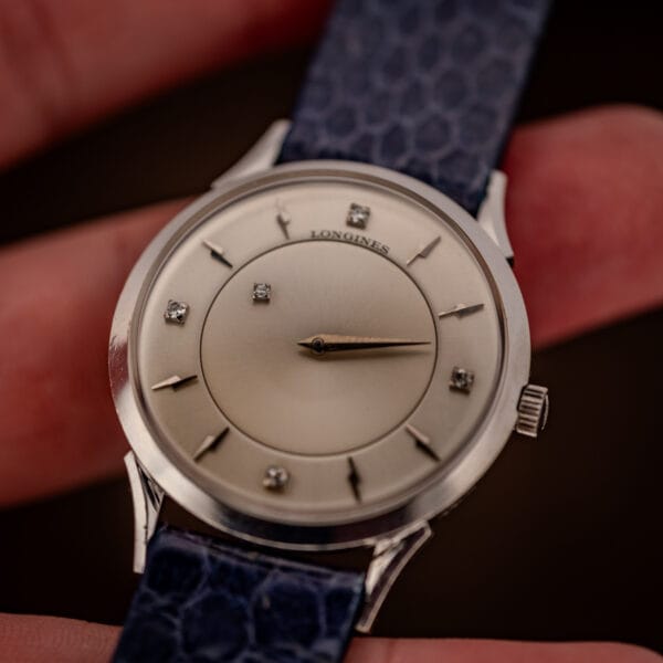 Longines mystery dial 69-230-2A held in hand, full silver dial with floating gold hands