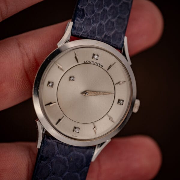 Longines mystery dial in hand showing LONGINES and SWISS dial signatures and diamond markers