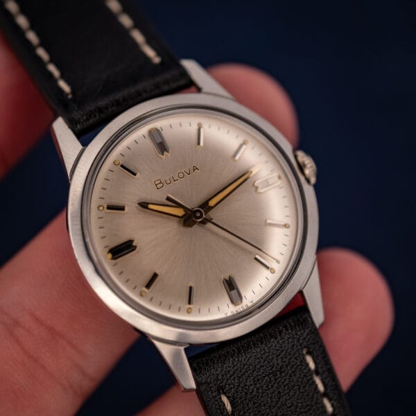 Vintage Bulova cal. 11BLC sunburst dial held in hand showing T SWISS T tritium and signed crown