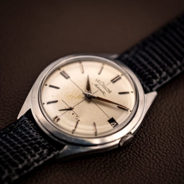 Vintage LeCoultre E329 stainless case and cream cross-hair dial at a three-quarter angle on leather strap
