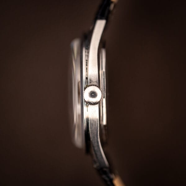 LeCoultre E329 stainless case band and fluted crown in tight side-profile macro
