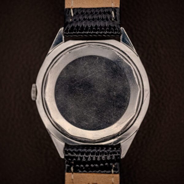 LeCoultre E329 brushed stainless caseback and faceted lugs on black lizard-grain leather strap