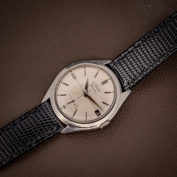 LeCoultre E329 cream dial, date at three and LeCoultre Automatic signature, angled on leather
