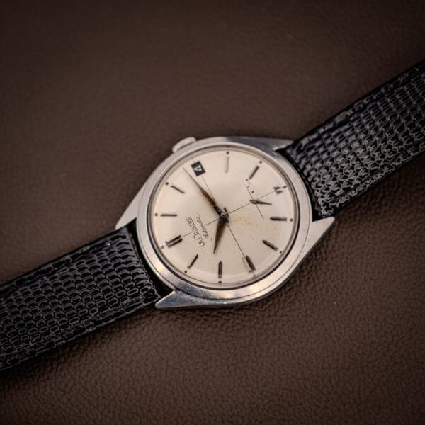 Vintage LeCoultre Automatic E329 cross-hair dial and sub-seconds angled on brown leather
