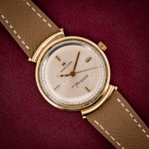 Hamilton Thin-O-Matic T-406 silver sunburst dial with cross-H logo and Thin-o-matic script in gold hooded-lug case