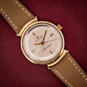 Hamilton Thin-O-Matic T-406 silver sunburst dial with cross-H logo and Thin-o-matic script in gold hooded-lug case