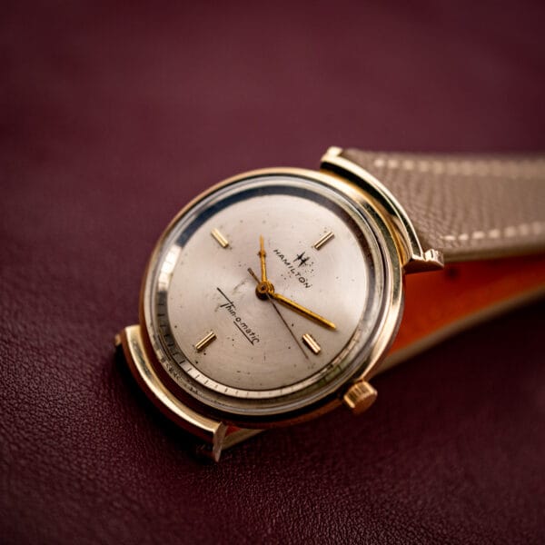Hamilton Thin-O-Matic micro-rotor automatic with gold hooded lugs and silver sunburst dial in three-quarter view