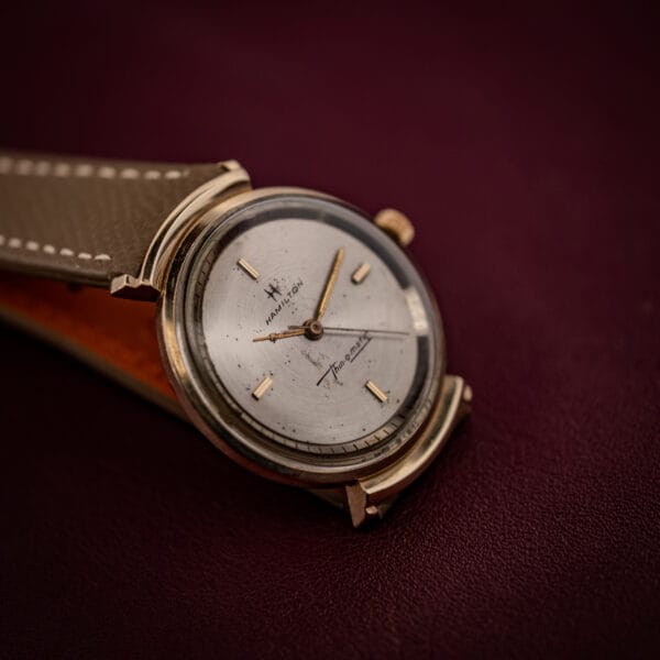 Hamilton Thin-O-Matic Cal. 663 silvered dial and tall domed crystal in a low-angle view of the gold-filled case