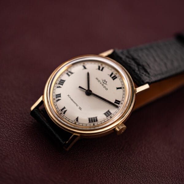 Movado Kingmatic S three-quarter view, glossy white Roman numeral dial under a domed crystal