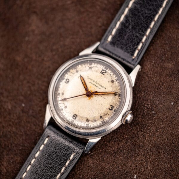 Vintage Girard-Perregaux bumper automatic at an angle showing stepped faceted lugs and small crown