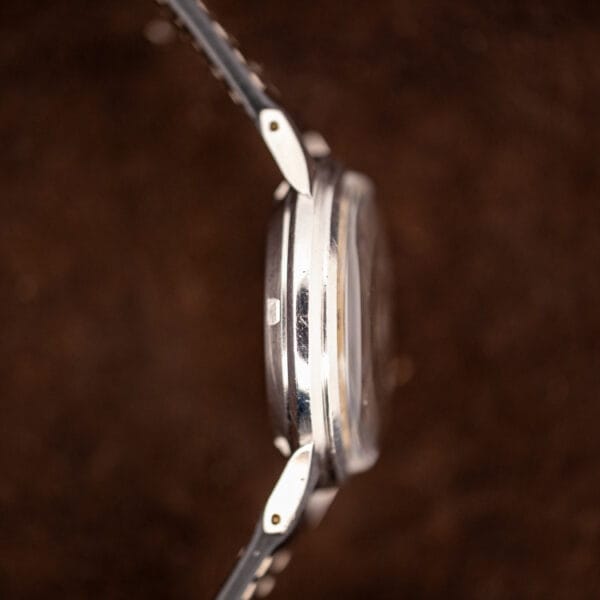 Side view of the Girard-Perregaux stainless steel case and faceted lugs on a black leather strap