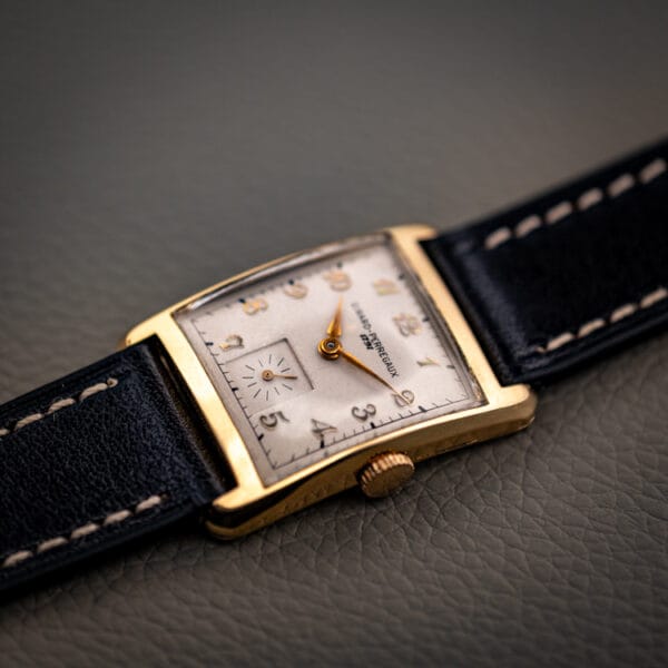 Girard-Perregaux 1791 gold filled tank at an angle showing curved downturned lugs and the dial signature