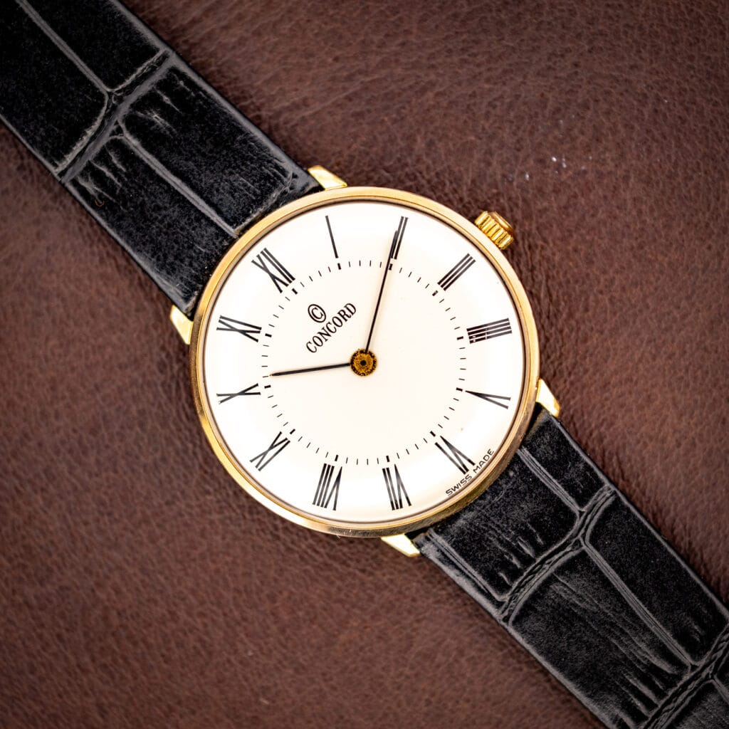 Vintage Concord gold plated dress watch, white dial with black Roman numerals on a black leather strap