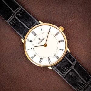 Vintage Concord gold plated dress watch, white dial with black Roman numerals on a black leather strap