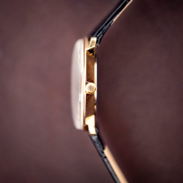 Concord slim dress watch side profile, thin gold plated case and domed crystal