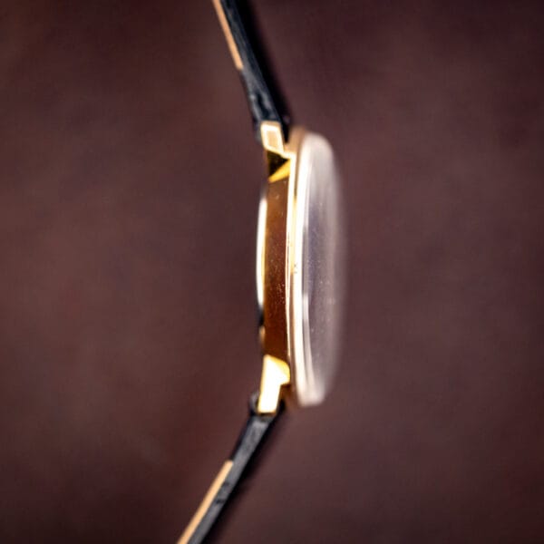 Concord ultra slim gold plated case side view with domed crystal and gold crown