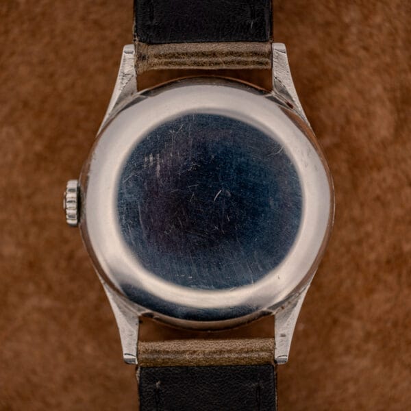 Omega 2391 plain stainless steel snap caseback showing honest hairline wear from decades on the wrist