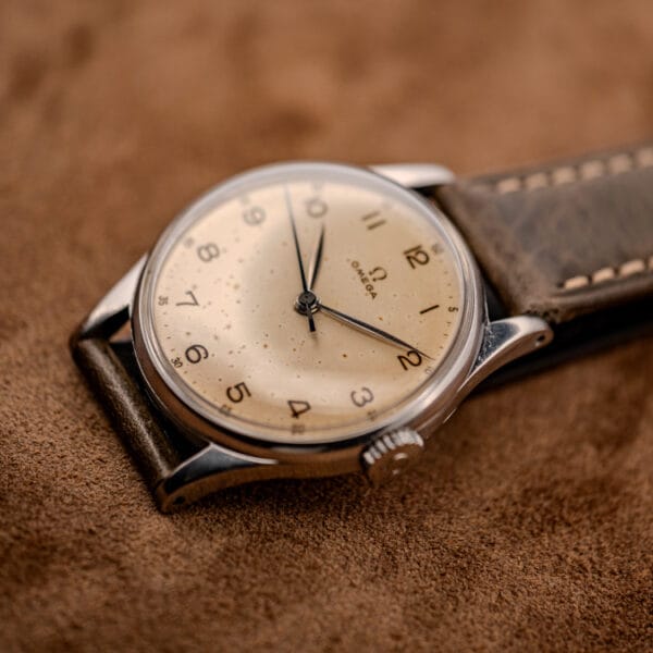 Omega 2391 three-quarter view showing the domed crystal, faceted lugs and signed Omega crown