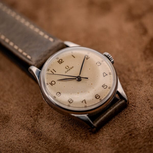 Vintage Omega 30T2 SC ref. 2391 side angle on suede, stainless steel case and olive leather strap