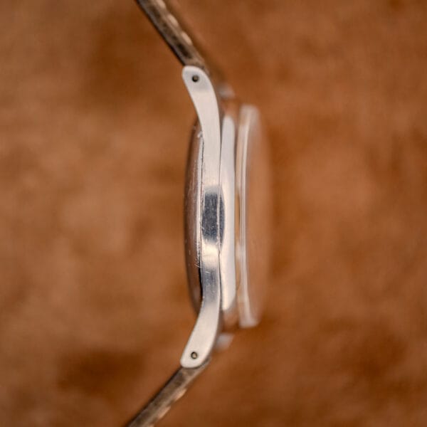 Omega 2391 case profile, proud domed crystal over polished lugs and a thin stainless steel band