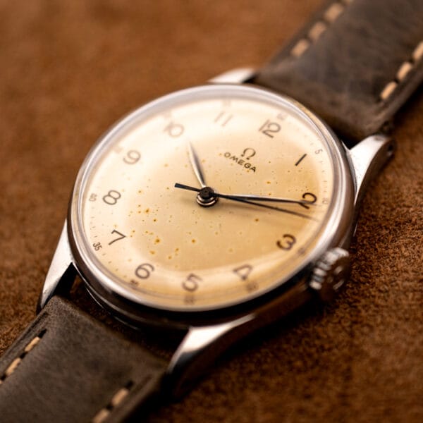 Omega 30T2 SC ref. 2391 hero angle, champagne tropical dial with foxing on an olive strap and OTTUHR buckle