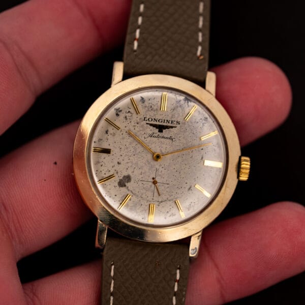 Longines Automatic 2264-1 held in the hand, mud grey strap, showing dial patina and gold filled case size