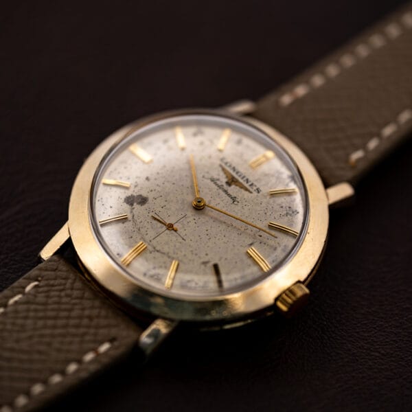 Vintage Longines 2264-1 automatic three-quarter beauty shot, gold filled case and speckled dial on grey strap