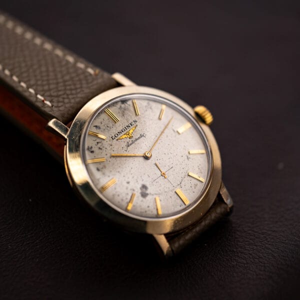 Longines 2264-1 automatic gold filled case angled on dark leather, LONGINES Automatic dial with grey speckle