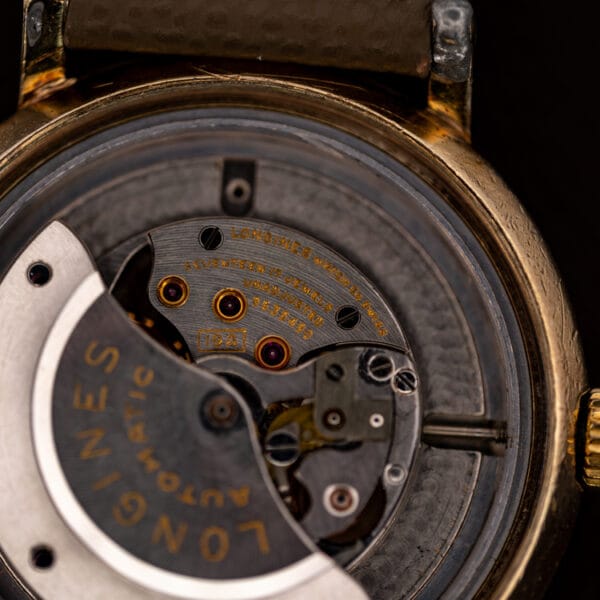 Longines 19A movement bridge stamped LONGINES WATCH CO SWISS, SEVENTEEN 17 JEWELS, jewels set in gold chatons