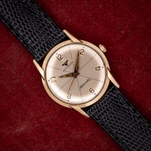 Vintage Wittnauer Automatic 2673-11SR silvered starburst dial with applied gold Arabic numerals on a black lizard strap