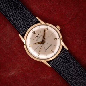 Vintage Wittnauer Automatic 2673-11SR silvered starburst dial with applied gold Arabic numerals on a black lizard strap
