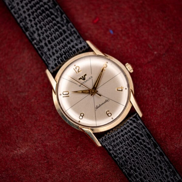 Vintage Wittnauer 2673-11SR gold filled automatic angled on burgundy, silvered sector dial and faceted lugs visible