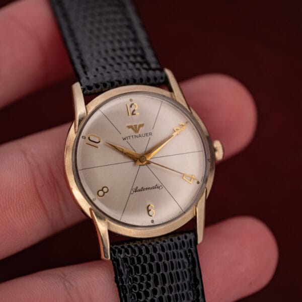 Vintage Wittnauer Automatic 2673-11SR held in hand showing the compact gold filled case and silvered starburst dial