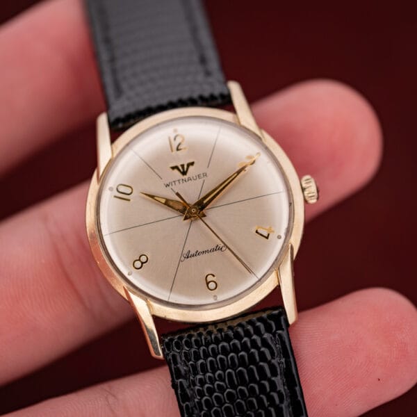 Wittnauer 2673-11SR in hand, fluted crown at three and domed acrylic crystal over the silvered sector dial