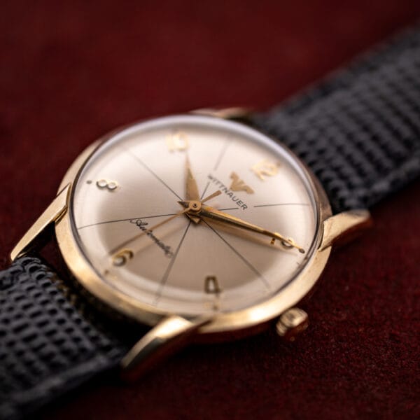 Wittnauer 2673-11SR angled profile showing the tall domed acrylic crystal and gold filled faceted lugs