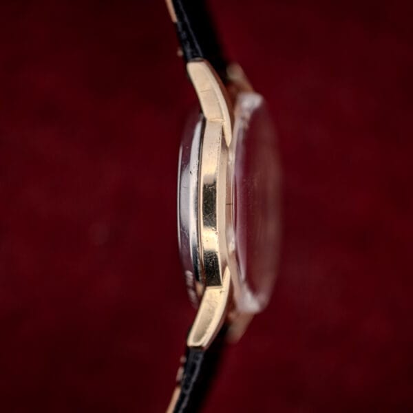 Wittnauer 2673-11SR case side profile showing the domed acrylic crystal and two-tone gold filled and steel construction