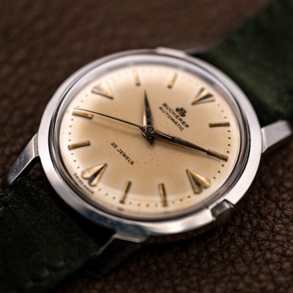 Bucherer automatic 6232 eggshell dial and polished steel case at three-quarter angle on brown leather