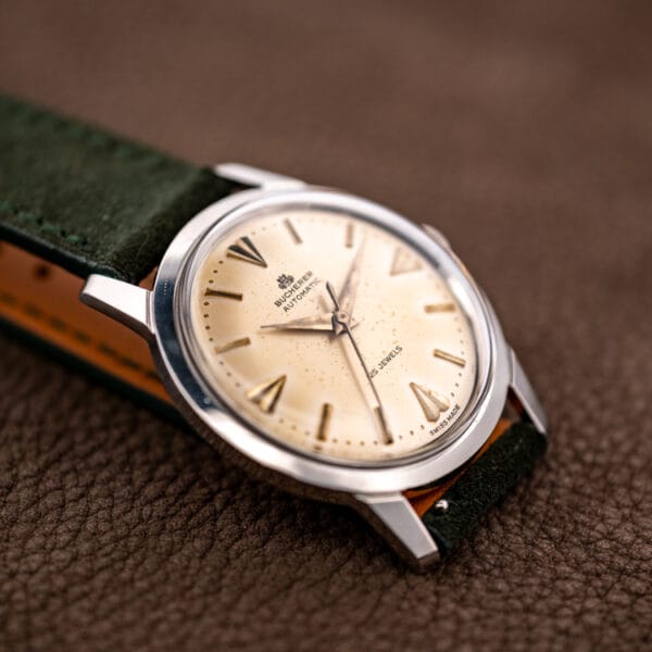 Bucherer Ref. 6232 dial and lugs at a dynamic angle showing faceted gilt markers and sweep seconds