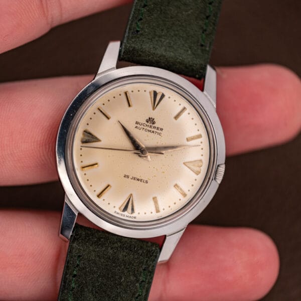 Vintage Bucherer 6232 automatic held in hand showing compact 35mm stainless steel proportions