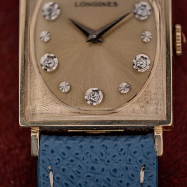 Longines 3007-528 dial macro showing round diamonds in white rosette settings alternating with faceted star markers
